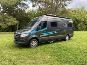 Avida campervan parked on green grass, showcasing modern design and features, relevant to campervans for sale in Gold Coast.