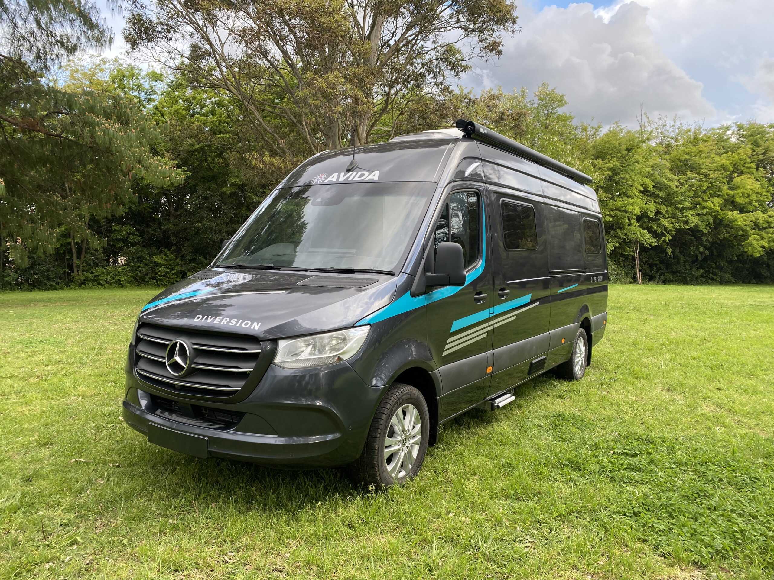 Avida Diversion campervan parked in lush green grass, showcasing modern design and features, relevant to campervan sales and negotiation tips in Gold Coast.