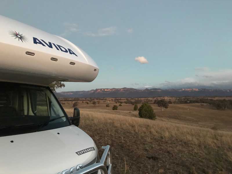 Avida Esperance motorhome parked in scenic countryside with mountains in the background, showcasing outdoor travel and exploration.