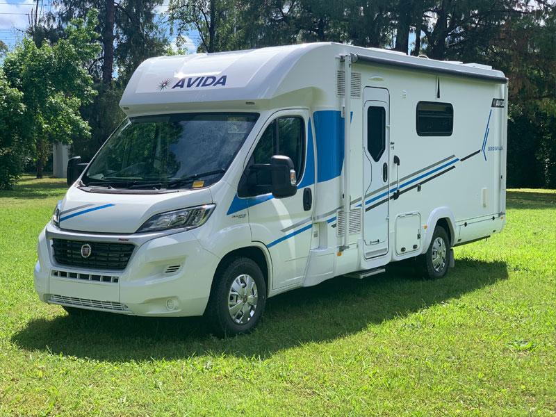 Avida campervan parked on green grass, showcasing its sleek exterior design and brand logo, relevant for tips on campervan storage in Australia.