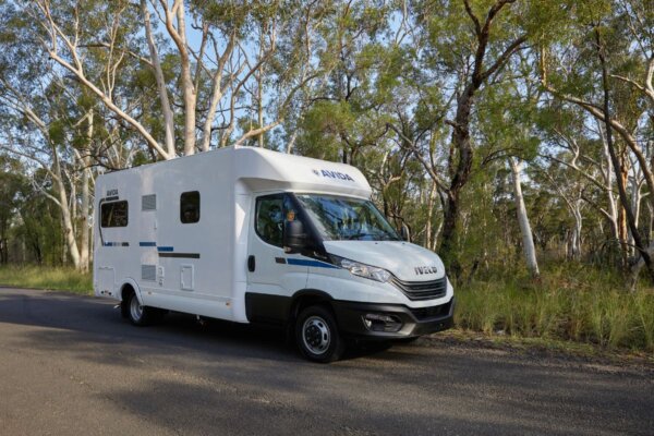 Avida Bruny motorhome parked on a scenic road, showcasing its sleek design and spacious layout, surrounded by trees in a natural setting.